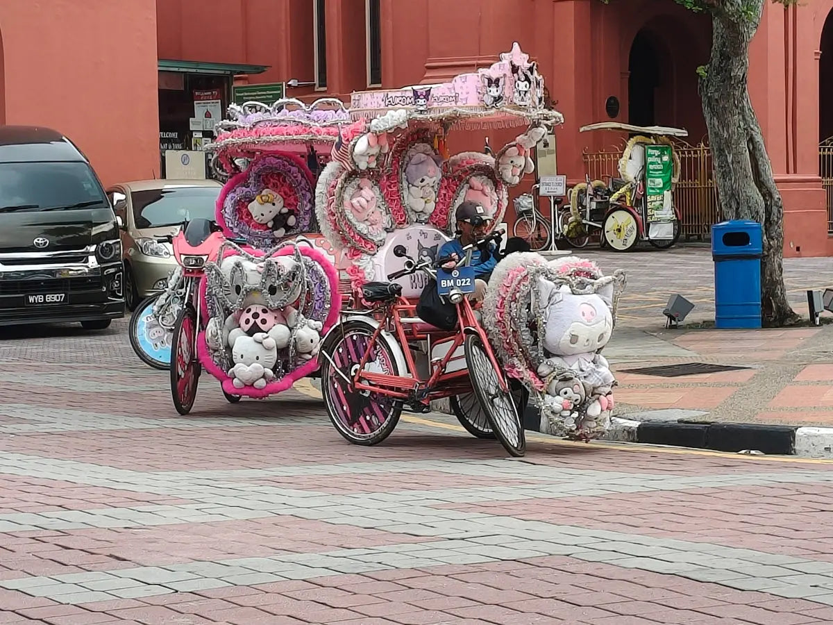 Pink hello kitty themed trishaw decorated with plush toys